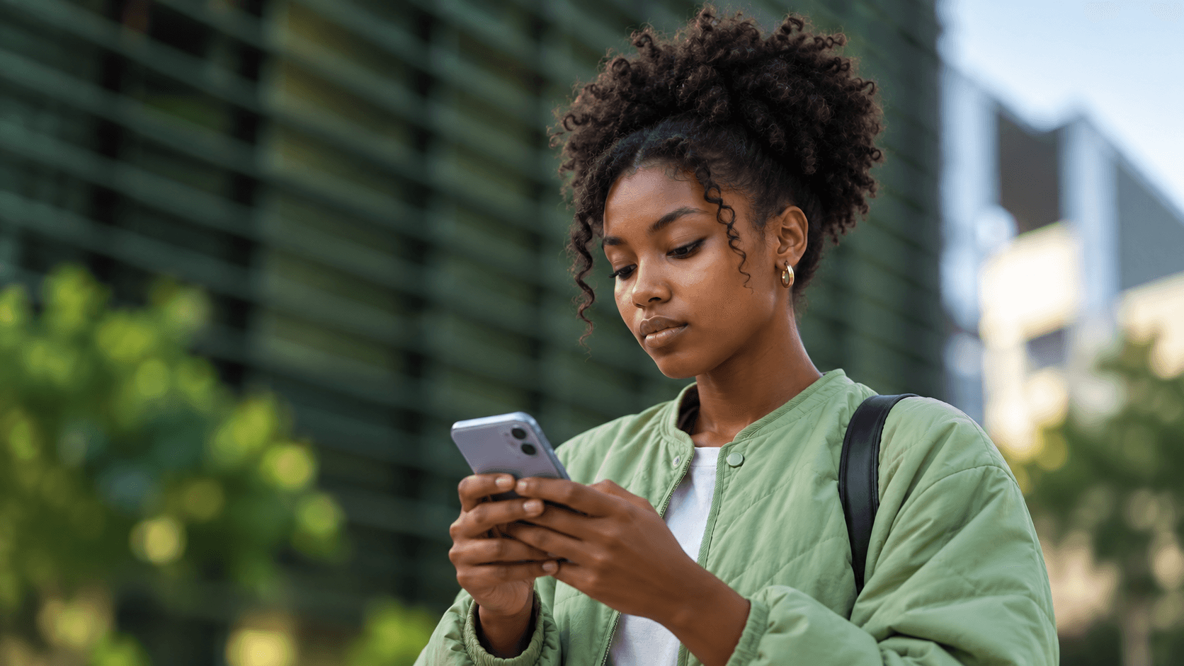A woman reading an SMS on her phone